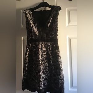 BCBG-black lace,silver-underlay, V-neck, pockets, scalloped hem cocktail dress.